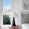 a bedroom with a lamp and a window