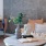 a room with a couch and a table with a vase of flowers